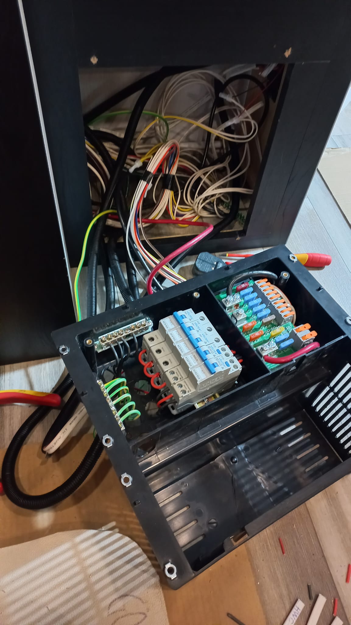 Technician performing maintenance on a caravan's electrical system