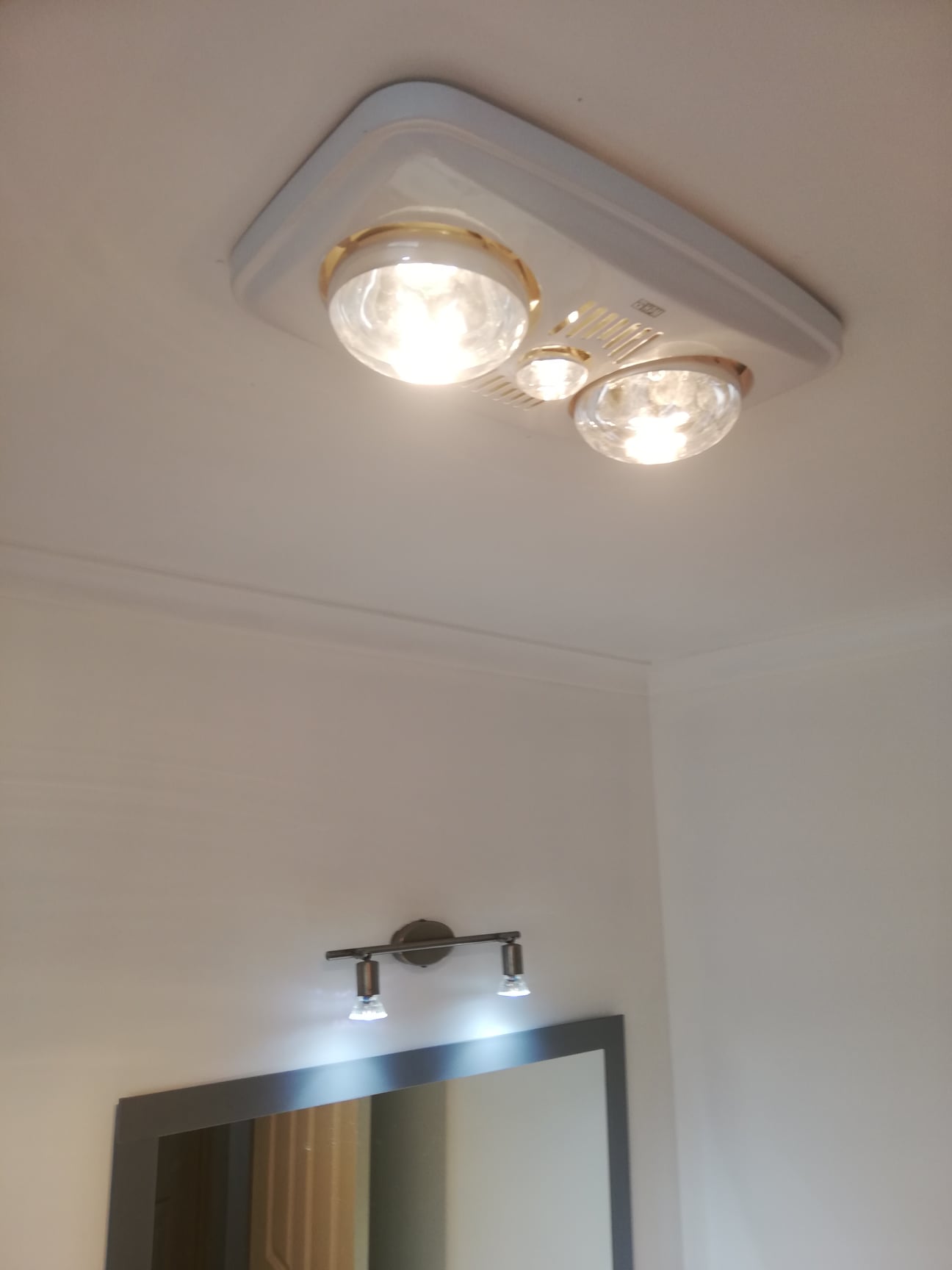 Contemporary bathroom with heated towel rail and vanity lighting